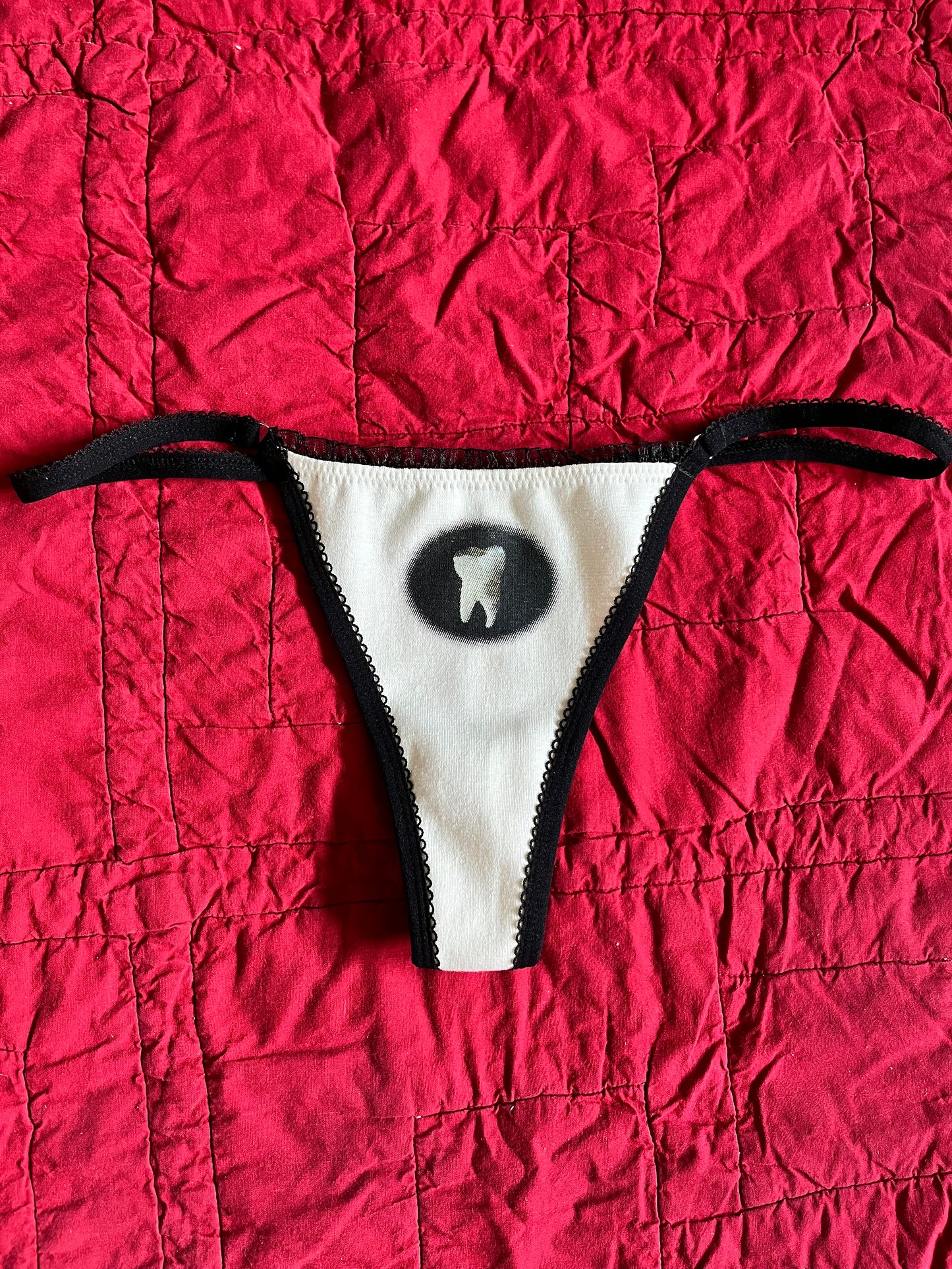 L TOOTH THONG